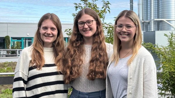 Three NETZSCH Pumps & Systems apprentices smiling outdoors, representing teamwork and professional development during their excursion.