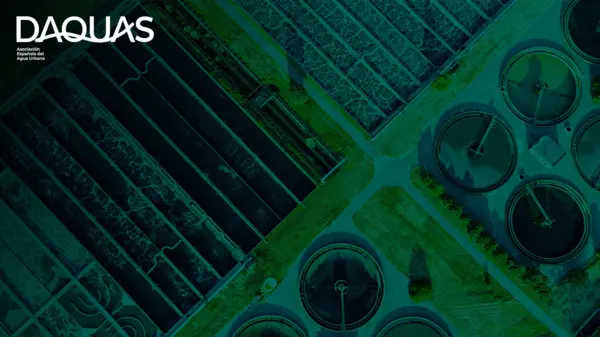 Aerial view of modern wastewater treatment facilities, showcasing circular tanks and treatment processes for sustainable urban water management.